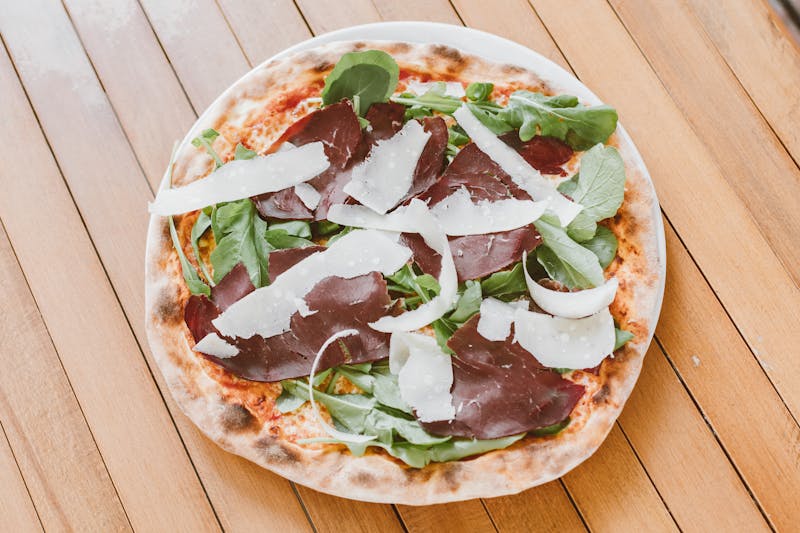 Vegan pizza with roasted vegetables and plant-based cheese